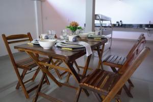 a wooden table with bowls and plates on top of it at Pousada Pelo Sertão in Piranhas