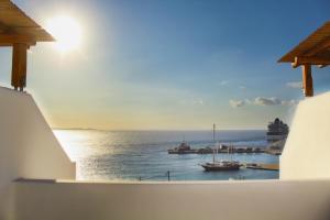 a view of a harbor with a cruise ship in the water at Calistus Mykonos in Mikonos