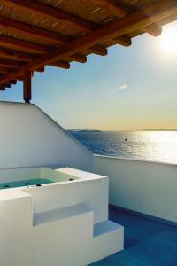 a white house with a view of the ocean at Calistus Mykonos in Mikonos