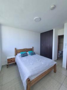 Säng eller sängar i ett rum på Apartamento en Playa Blanca