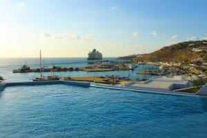 a swimming pool with a view of a marina at Calistus Mykonos in Mikonos