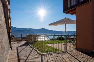 a balcony with an umbrella and a view of the ocean at Dali' in Parzanica