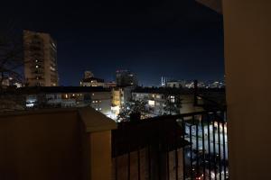 a view of a city skyline at night at Etern Stays IEG - Maroon Apartment in Prishtinë