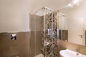a bathroom with a shower with a sink and a mirror at Il Duomo Salerno in Salerno +31 photos