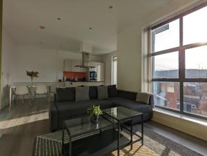 a living room with a couch and a table at Bankside by Wycombe Apartments in High Wycombe