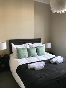 a large bed with two pillows on top of it at Number Nine Torquay in Torquay