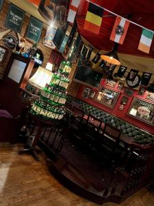 un bar con un montón de botellas de alcohol en Shoemaker Irish Pub & Accommodation, en Kielce