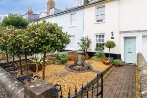 a garden in front of a house with a fountain at Beautiful Georgian Home in the heart of Chichester in Chichester