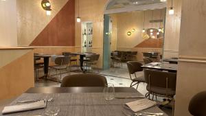 a dining room with tables and chairs in a restaurant at Hotel Roma in Bologna