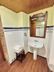 a bathroom with a sink and a mirror at Casa de los Somoza in Melide