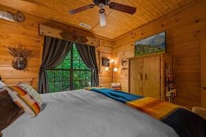 um quarto com uma cama e uma ventoinha de tecto em Dreamy Cabin & Outdoor Oasis! Mins to Nat'l Park! em Townsend