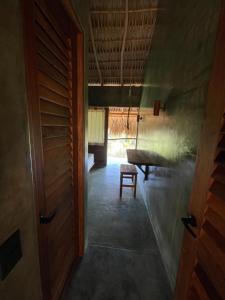 a hallway with a door and a bench in a room at COCOS HOTEL in Zipolite