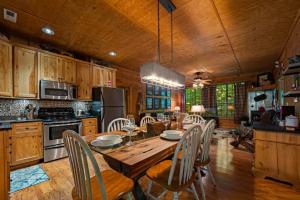 a large kitchen with a wooden table and chairs at Dreamy Cabin & Outdoor Oasis! Mins to Nat'l Park! in Townsend