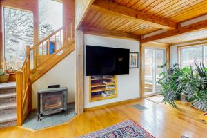 a living room with a fireplace and a flat screen tv at Newfane Hill Retreat in Newfane