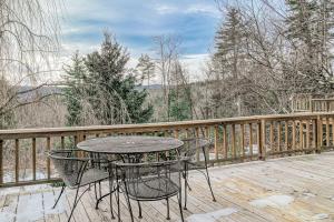 a table and chairs on a wooden deck at Newfane Hill Retreat in Newfane