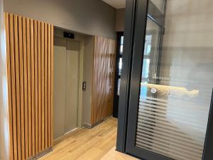 a hallway with a sliding glass door and a hallway with a hallway at Lavina MM2 in Kolašin