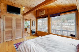 a bedroom with a bed and a large window at Newfane Hill Retreat in Newfane