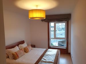 a bedroom with a bed and a large window at Welcome Here Parque Lumiar 1 in Lisbon