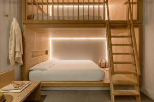 a bedroom with two bunk beds and a ladder at Zedwell Piccadilly Circus in London