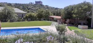 a garden with a swimming pool and a house at Guesthouse Ruža in Senj