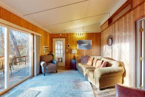 a living room with a couch and a patio at Ozark Rambler Cabin in Eureka Springs