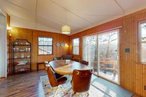 a dining room with a table and chairs at Ozark Rambler Cabin in Eureka Springs