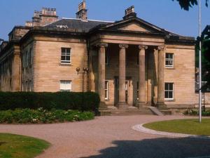 an old building with columns on a building at Wellpark Corner in Markinch