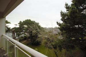 a balcony with a view of a yard with trees at Stella maris in Carnac