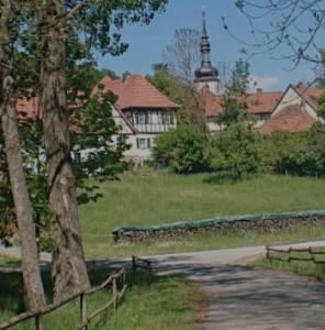 a path in a park with a building in the background at Ferienhaus Naturparadies Rhön in Willmars