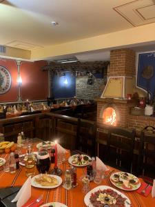 uma sala de jantar com uma mesa com pratos de comida em Hotel Iceberg Bansko em Bansko