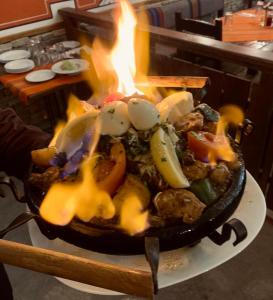 a pan of food with a fire in it at Hotel Iceberg Bansko in Bansko