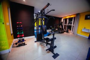 a gym with several tread machines in a room at Roma Hotel in Bacabal
