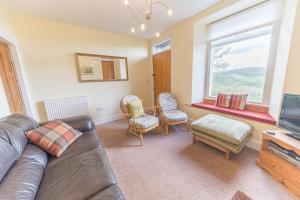 a living room with a couch and chairs and a tv at Lakeland View Coniston in Coniston