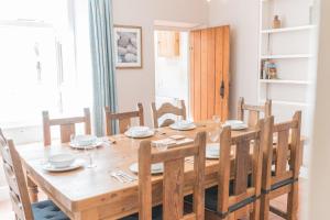 a dining room with a wooden table and chairs at Lakeland View Coniston in Coniston