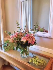 a vase filled with flowers sitting on a table at Nice Garden Hotel in Nice