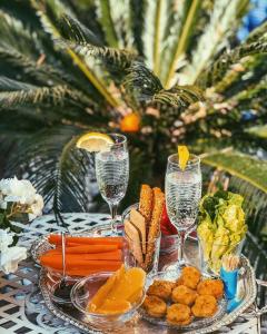 a table with two plates of food and wine glasses at Nice Garden Hotel in Nice