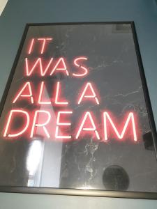 a neon sign that says it was all a dream at The Metropolitan Guest House in Whitley Bay