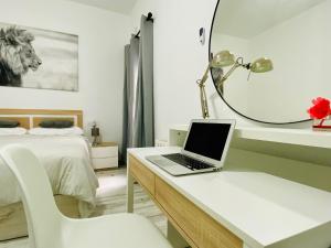 a bedroom with a desk with a laptop on it at COSTASOL PLAZA - PREMIUM CLASS - Apartamento céntrico moderno - 3BED 2ROOM 6PEOPLE - in Córdoba