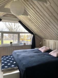 a bedroom with a large bed with an american flag blanket at Ferienhaus am Vänern mit Seeblick in Mariestad