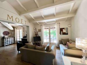 a living room with two couches and a tv at Jolie maison - Place des Lices à 350m in Saint-Tropez