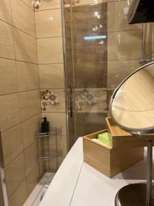 a bathroom with a shower and a mirror at Apartament Nowowierzbowa 16 Zawiercie in Zawiercie
