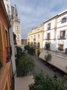 a city street with buildings and a clock tower at Duplex Luxury Giralda with terrace in Seville