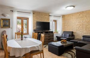 a living room with a couch and a table at Holiday Home By The Sea--Bougainvillea in Ston