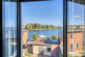 a view of a river from a window at BlueSea mit Seeblick und Badewanne in Malchow