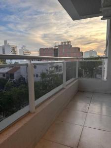 a balcony with a view of a city skyline at DEPTO EN AV ROCA PARA HASTA 4 PERSONAS - Edificio MIRÓ1 in Santiago del Estero