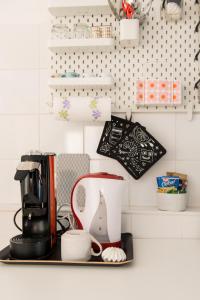 a kitchen counter with a coffee maker on a shelf at Centrale APT con terrazza a 5min dal Pitti! - HomeUnity in Florence
