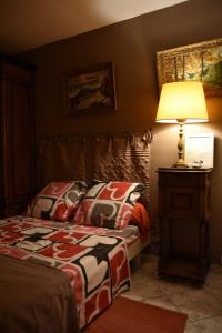 a bedroom with a bed and a lamp on a table at Residence Privée in Nice