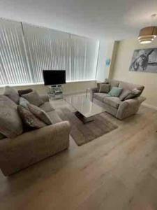 a living room with two couches and a coffee table at Winter Gardens North Pier Home in Blackpool