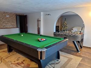 a room with a pool table and a christmas tree at Nad Lasem in Bukowina Tatrzańska