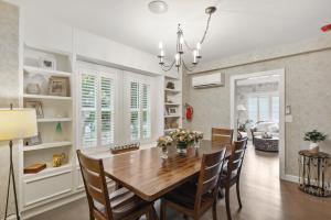 a dining room and living room with a table and chairs at The Stirrup House by Pattio in Miami